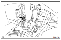 REMOVE FRONT SHOCK ABSORBER WITH COIL SPRING