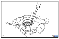 REMOVE FRONT WHEEL BEARING DUST DEFLECTOR